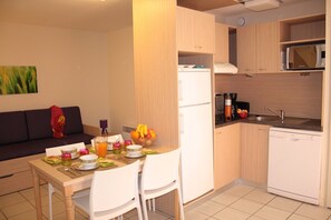 Prepare meals in the kitchenette and enjoy them at the dining table.