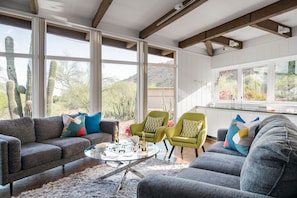 Floor to ceiling windows brighten this colorful and eclectic mid-century modern home.