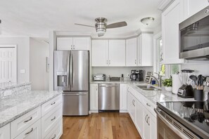 New Designer Kitchen with Granite Countertop and Stainless Steel Appliances.
