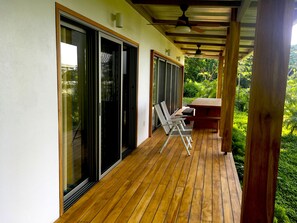 Deck extends entire length of house with deck chairs and cedar table sits 6-8 p