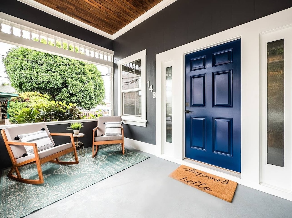 This Airbnb Maui, with a front porch with rocking chairs and a blue front door, is one of this best places to stay in maui on a budget