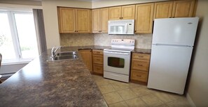 Fully stocked kitchen with dishes, spices, etc