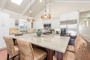 The large kitchen island serves as the indoor dining area.