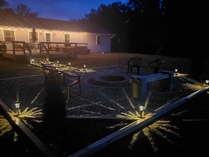 View from outside of the firepit, looking towards the hosue and lake.