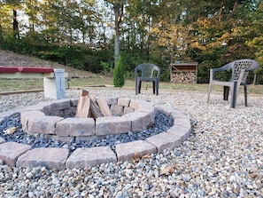 View of the firepit in the private back yard. Firewood is always stocked.