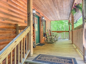 A welcoming, covered front porch, complete with rockers, greets you on arrival.