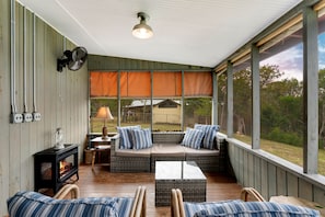 Comfy screen porch seating area with hummingbirds and sunsets!