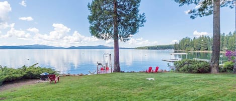 Spectacular view with large lawn leading to private boat dock