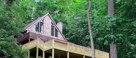 The Mountain Chalet with newly added deck, hot tub, corn hole set and ping pong.