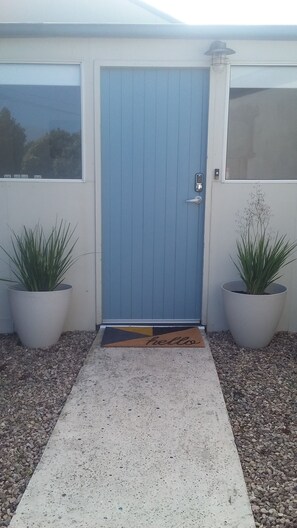 Keyless entry. Sunny and sheltered courtyard with water feature and seating.