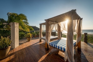 The front deck spans the white sands has beautiful beach beds to relax on