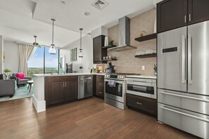 Kitchen with 5 burner gas stove, microwave, dishwasher and plenty of storage