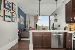 Full kitchen with open view of the living room