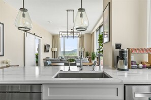 View from kitchen sink and open concept to dining and living room