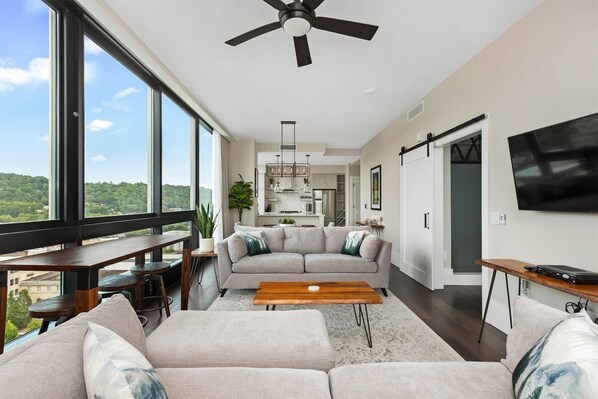 Living room with two sleeper sofas, 55 inch TV and high top table