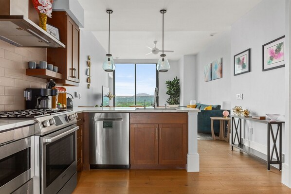 Kitchen with 5 burner gas stove, dishwasher, microwave, Keurig Duo and refrigerator