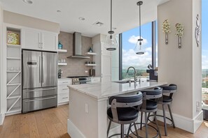 Kitchen with microwave, dishwasher, 5 burner gas stove and breakfast counter