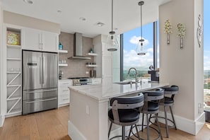 Kitchen with microwave, dishwasher, 5 burner gas stove and breakfast counter