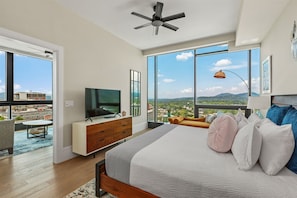 Bedroom with king bed, additional seating and 55 inch TV