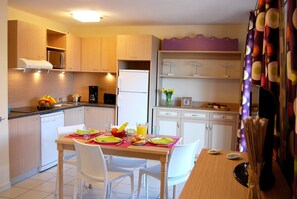 Prepare meals in the kitchenette and enjoy them at the dining table.