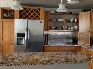 Modern Kitchen - Stainless steel back-splash, sink, and Brazilian granite.