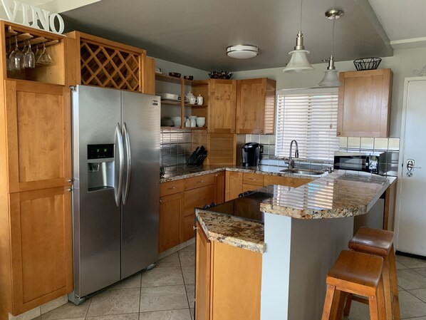 Modern Kitchen - Stainless steel back-splash, sink, and Brazilian granite.