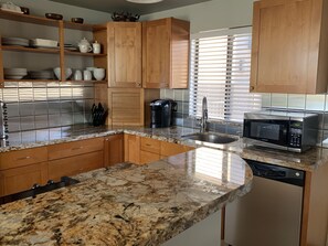 Modern Kitchen - Stainless steel back-splash, sink, and Brazilian granite.