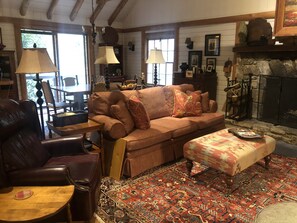 great room with wood burning fireplace and vaulted ceiling