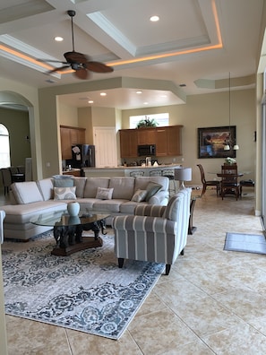 Great room with coffered ceiling, wet bar and open concept kitchen