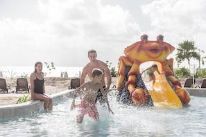 Kids new pool with many slides and fun by the beach.