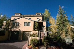 Summer view of townhouse from front.  Plenty of room outside to play.