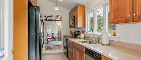 Well equipped galley style kitchen with dishwasher and garbage disposal