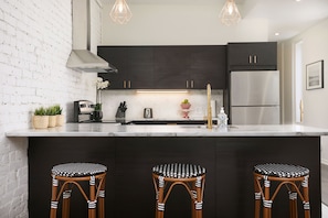 Breakfast counter with French hand woven bistro chairs, coffee, tea, cookies