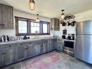 Modern appliances and fully equipped kitchen with 100 year aged wood cabinets