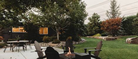 "We enjoyed the backyard with the beautiful flowers and manicured lawn complimented by the string lights, the Adirondack chairs and fire pit"
       - Marinela 