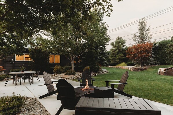 "We enjoyed the backyard with the beautiful flowers and manicured lawn complimented by the string lights, the Adirondack chairs and fire pit"
       - Marinela 