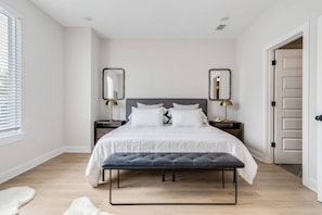 Spacious master suite has a memory foam king bed, massive walk-in shower with double vanities in the bathroom, and a 55-inch TV.