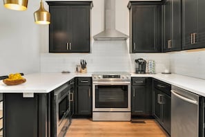 Hello, gorgeous! The kitchen has high-end stainless appliances and everything you need to prepare and enjoy a meal in.