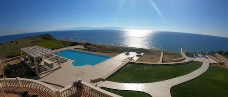 View from kitchen terrace over the pool and BBQ area towards the Ionian sea
