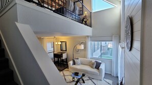 Stairs lead to the loft over looking the living room.