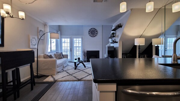 Open concept living space has is open to loft above.