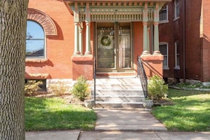 Take the stairs up to the ornate front entrance with plenty of parking at the front of the house