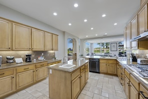 Large fully stocked kitchen with views overlooking pool and 18th fairway