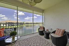 BH302 - Sliding doors open up from the living to the screened in balcony with amazing view overlooking the lake and community pool. Perfect spot to start the day with a morning coffee outside while looking at the spectacular sunrise!
