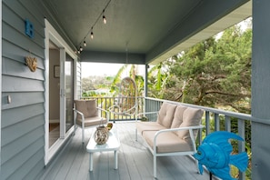 Sit and enjoy the balcony while listening to the waves crash