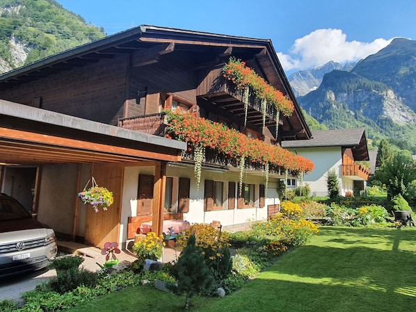 Plant, Sky, Building, Property, Flower, Window, Mountain, Tree, House, Cloud