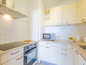 Cabinetry, Building, Countertop, Drawer, Kitchen, Kitchen Appliance, Kitchen Stove, Lighting, Wood, Interior Design