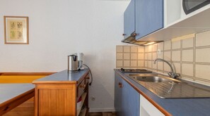 Curb your appetite by cooking a meal in your kitchen.