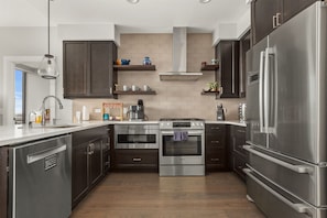 Kitchen with 5 burner gas stove, dishwasher, microwave, Keurig and refrigerator