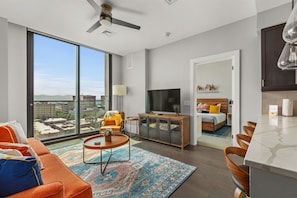 Living room with sleeper sofa, 55 inch TV and sliding window